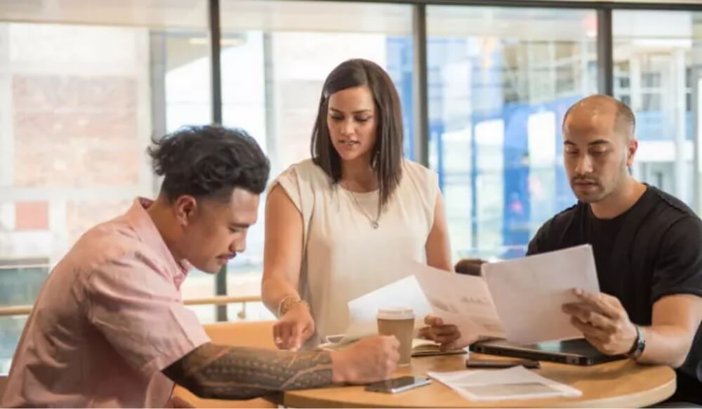 Colleagues reviewing documents together at a table